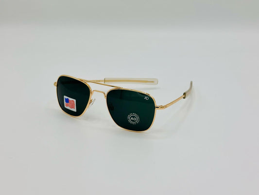 Gold-framed aviator sunglasses with green lenses on a white background


