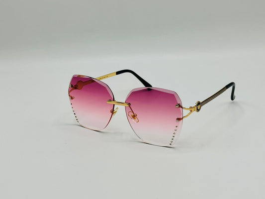 Rimless gradient pink sunglasses with gold temples and rhinestone edges